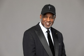 Pastor Glass in tuxedo with cross cap - smiling