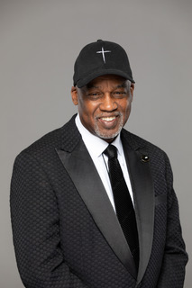 Pastor Glass in cross cap - warm smile